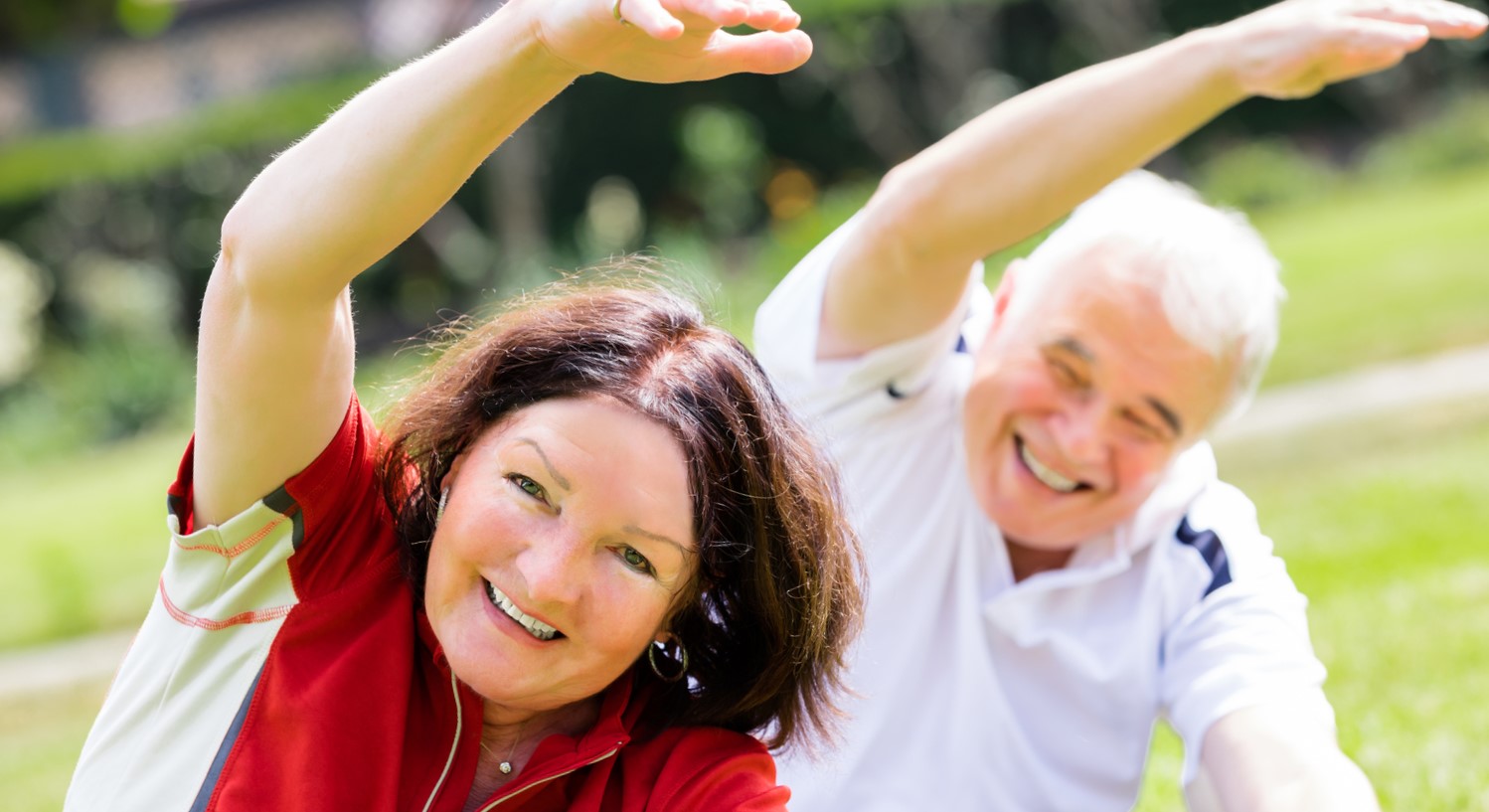 Happy Couple Exercising In Park